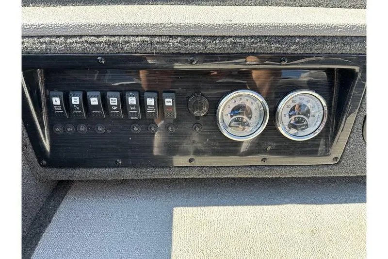 Slide: The Image of Control panel of 2021 Starcraft Delta 168 Tiller boat with gauges and switches. - 22
