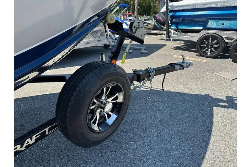 Slide: The Image of 2021 Starcraft Delta 168 Tiller boat trailer with Yamaha F70LA, featuring sleek black wheels. - 28