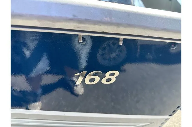 Slide: The Image of Close-up of 2021 Starcraft Delta 168 Tiller boat exterior with model number visible. - 7