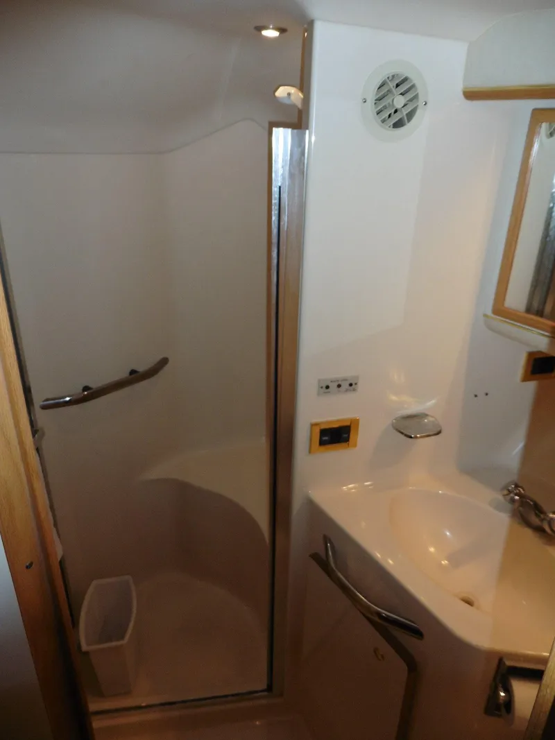 Slide: The Image of Bathroom interior of 1997 Sea Ray 440 Express Bridge yacht, featuring shower and sink. - 16