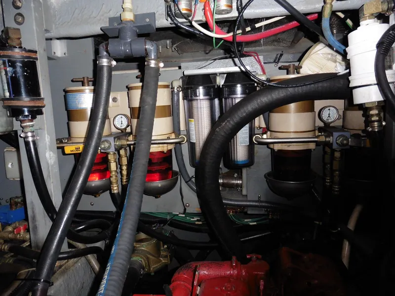Slide: The Image of Engine room of 1997 Sea Ray 440 Express Bridge with fuel filters and hoses. - 25