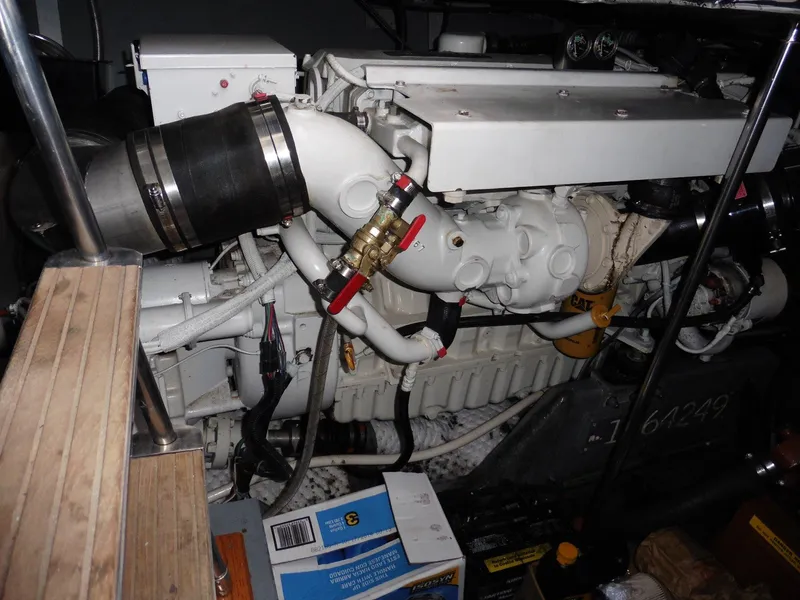 Slide: The Image of Engine room of a 1997 Sea Ray 440 Express Bridge, showcasing mechanical components and piping. - 27