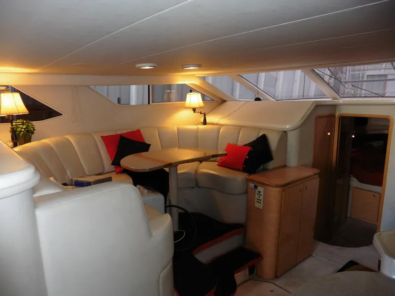 Slide: The Image of Luxurious interior of 1997 Sea Ray 440 Express Bridge with plush seating and ambient lighting. - 3