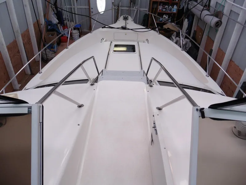 Slide: The Image of 1997 Sea Ray 440 Express Bridge yacht deck in storage, showcasing sleek design and spacious layout. - 30