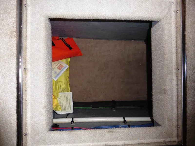 Slide: The Image of Storage compartment on a 1997 Sea Ray 440 Express Bridge with safety equipment. - 41