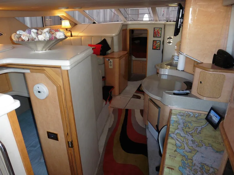 Slide: The Image of Interior of 1997 Sea Ray 440 Express Bridge with modern amenities and stylish decor. - 7