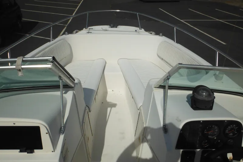 Slide: The Image of 1998 Boston Whaler 20 Ventura Bowrider with white seating and dashboard in a parking lot. - 12
