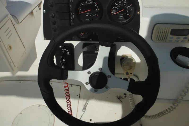 Slide: The Image of Steering wheel and dashboard of a 1998 Boston Whaler 20 Ventura Bowrider boat. - 13