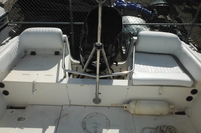 Slide: The Image of 1998 Boston Whaler 20 Ventura Bowrider interior with white seating and metal railings. - 17