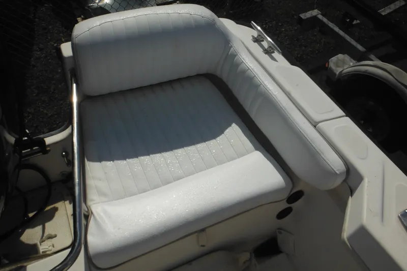 Slide: The Image of 1998 Boston Whaler 20 Ventura Bowrider seat with white upholstery and metal railing. - 19