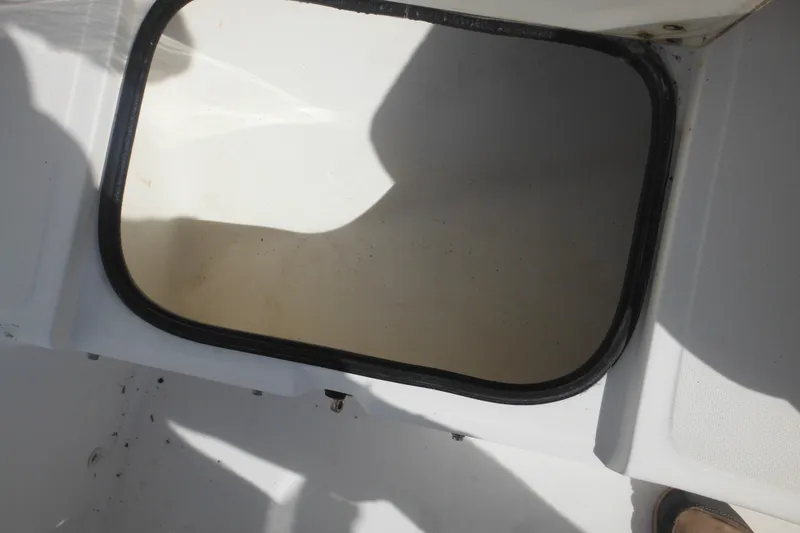 Slide: The Image of Open storage compartment on a 1998 Boston Whaler 20 Ventura Bowrider boat. - 28
