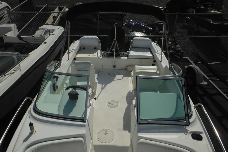 Slide: The Image of 1998 Boston Whaler 20 Ventura Bowrider with open deck and seating, docked in a marina. - 30