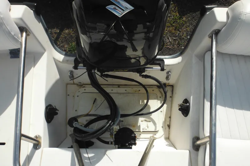 Slide: The Image of 1998 Boston Whaler 20 Ventura Bowrider engine compartment with visible wiring and seating. - 35