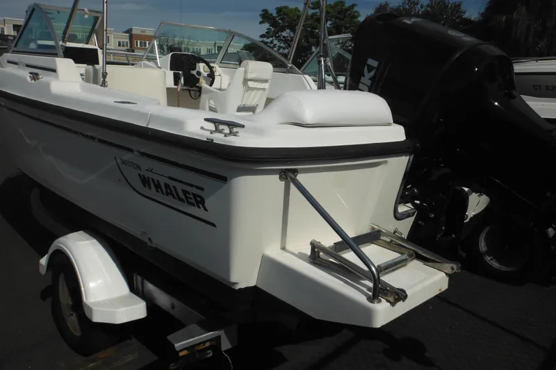 Slide: The Image of 1998 Boston Whaler 20 Ventura Bowrider on trailer, featuring outboard motor. - 5
