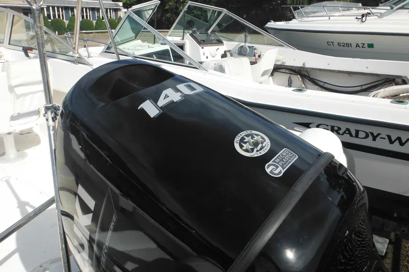 Slide: The Image of 1998 Boston Whaler 20 Ventura Bowrider with Suzuki 140 outboard engine, docked beside another boat. - 7