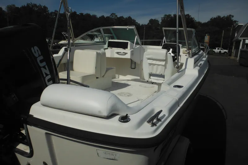 Slide: The Image of 1998 Boston Whaler 20 Ventura Bowrider with Suzuki outboard motor, docked outdoors. - 9