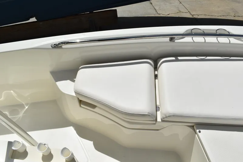 Slide: The Image of Boston Whaler 230 Dauntless 2010 boat interior with white cushioned seating. - 17