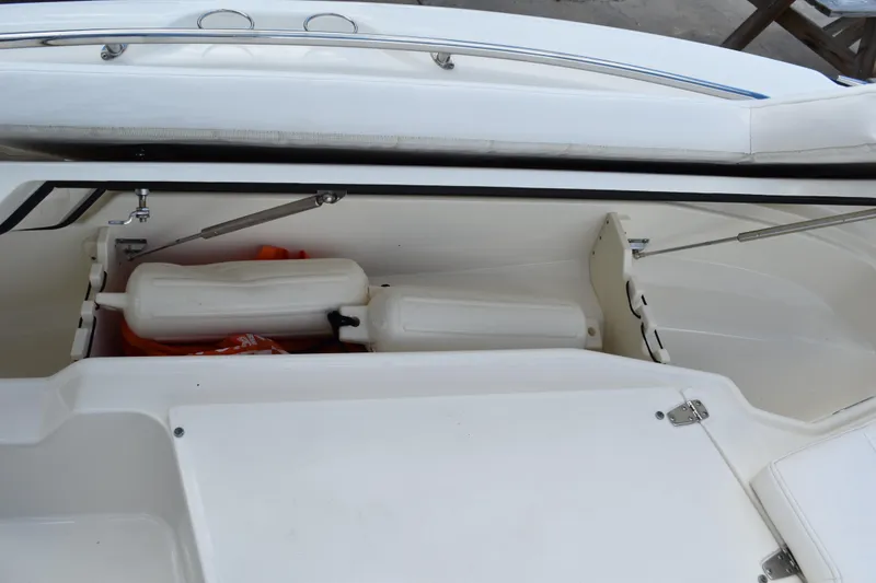Slide: The Image of Storage compartment of a 2010 Boston Whaler 230 Dauntless boat with fenders and life jackets. - 19