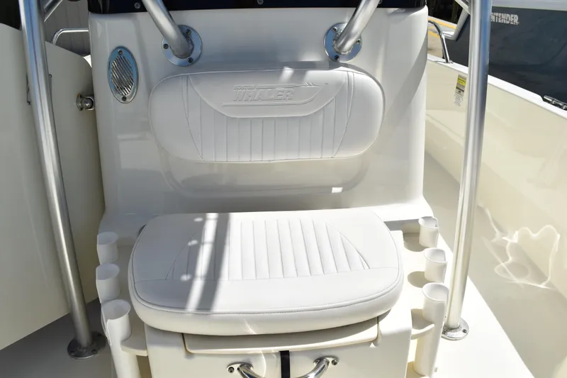 Slide: The Image of Boston Whaler 230 Dauntless 2010 boat seat with rod holders and white upholstery. - 26