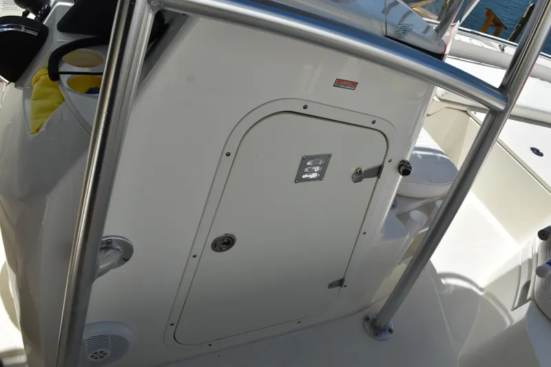 Slide: The Image of Boston Whaler 230 Dauntless 2010 boat interior with storage compartment and railing. - 29