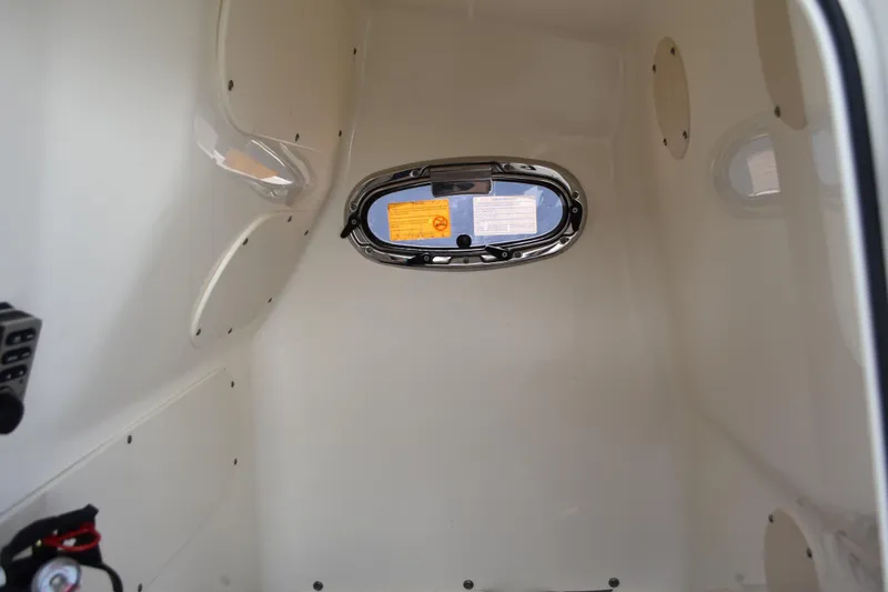 Slide: The Image of Interior cabin of 2010 Boston Whaler 230 Dauntless boat, featuring a small window. - 30