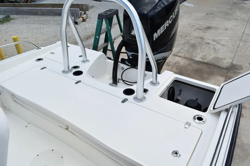 Slide: The Image of Boston Whaler 230 Dauntless 2010 boat deck with Mercury engine and storage compartments. - 35