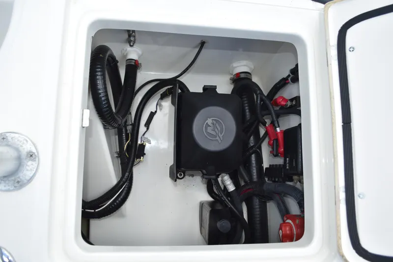 Slide: The Image of Electrical compartment of a 2010 Boston Whaler 230 Dauntless boat, showing wiring and components. - 38