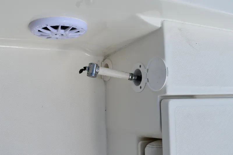 Slide: The Image of Interior detail of a 2010 Boston Whaler 230 Dauntless boat, featuring a speaker and rod holder. - 40