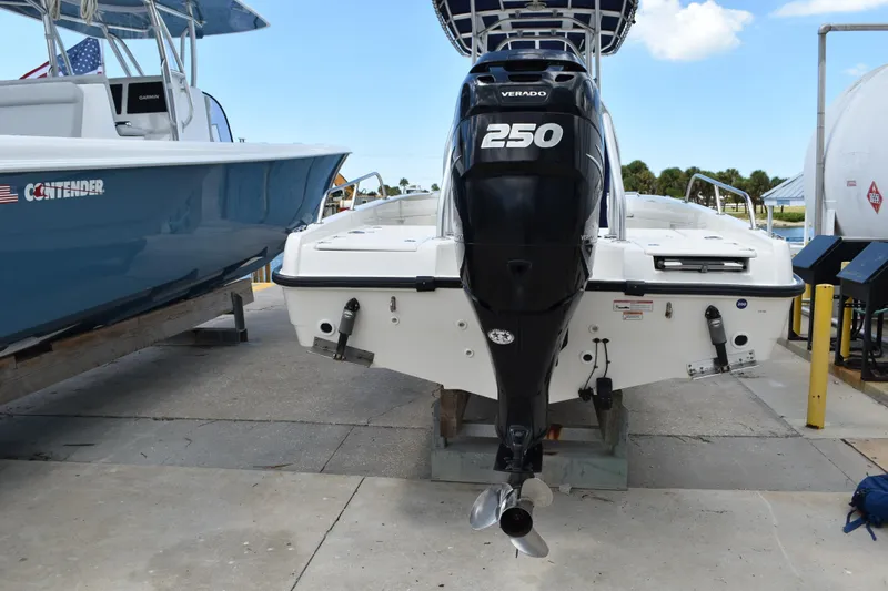 Slide: The Image of 2010 Boston Whaler 230 Dauntless with Verado 250 engine, docked beside another boat. - 41