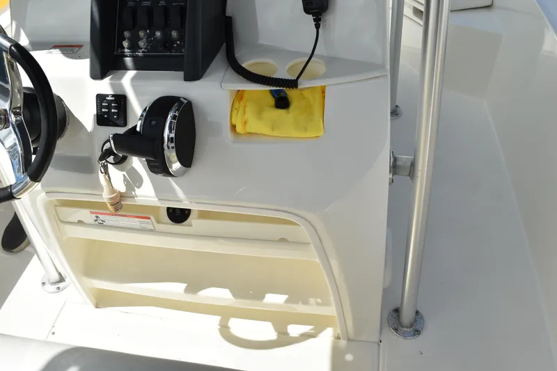 Slide: The Image of Boston Whaler 230 Dauntless 2010 console with steering wheel and controls. - 9