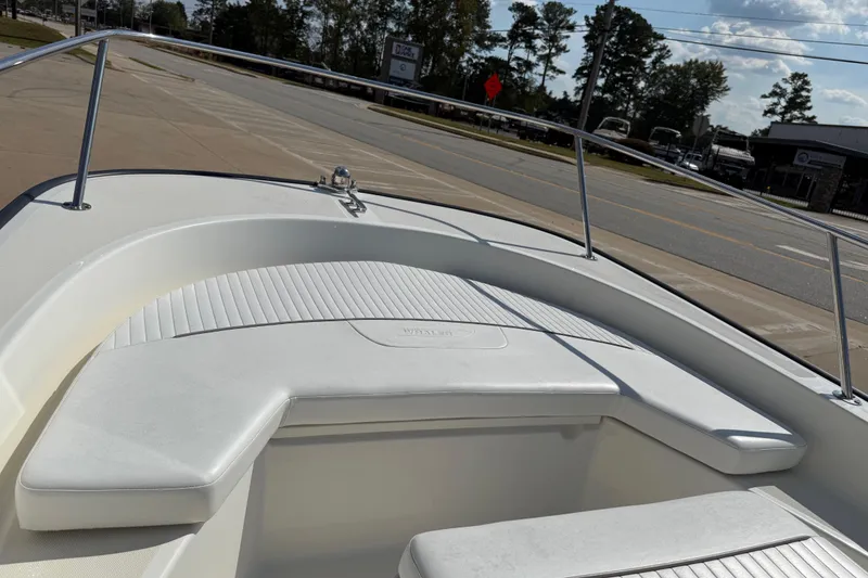 Slide: The Image of 2005 Boston Whaler 170 Montauk boat interior with white seating and railing. - 10