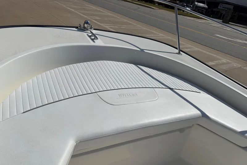 Slide: The Image of 2005 Boston Whaler 170 Montauk boat deck, featuring clean white surface and railing. - 11