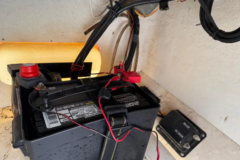 Slide: The Image of Battery setup in a 2005 Boston Whaler 170 Montauk boat, featuring wiring and connections. - 16