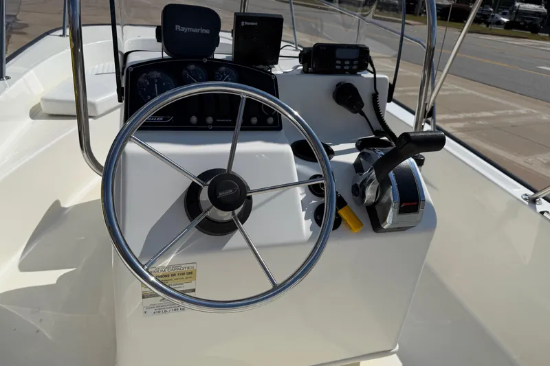 Slide: The Image of 2005 Boston Whaler 170 Montauk boat console with steering wheel and navigation equipment. - 18