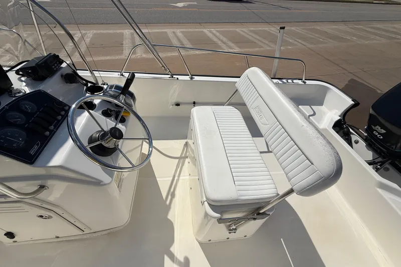 Slide: The Image of 2005 Boston Whaler 170 Montauk boat interior with steering wheel and seating. - 19