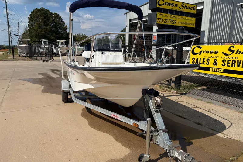 Slide: The Image of Boston Whaler 170 Montauk 2005 boat on trailer at sales and service center. - 2