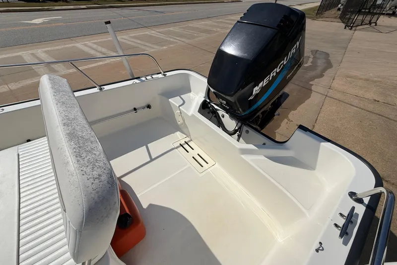 Slide: The Image of 2005 Boston Whaler 170 Montauk boat with Mercury outboard motor, viewed from the deck. - 20