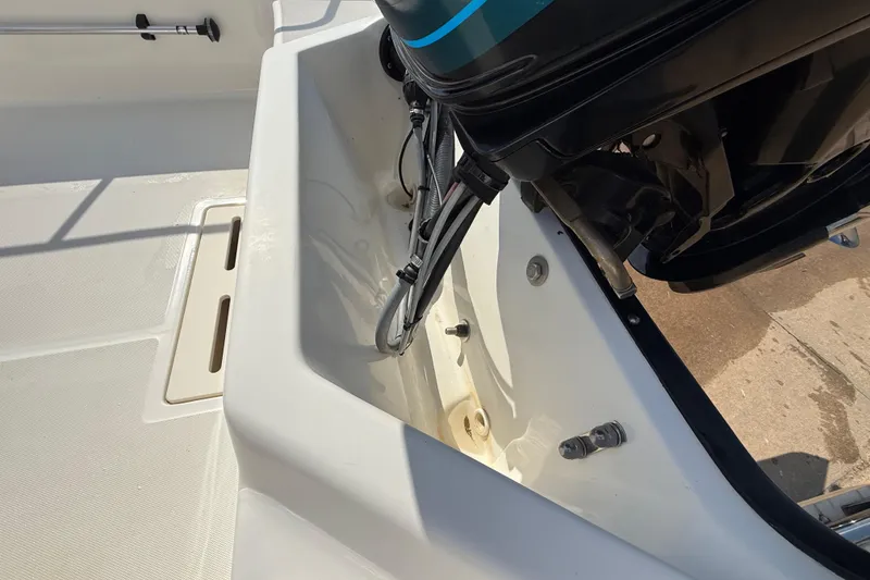 Slide: The Image of 2005 Boston Whaler 170 Montauk boat engine compartment, showing motor and interior details. - 21