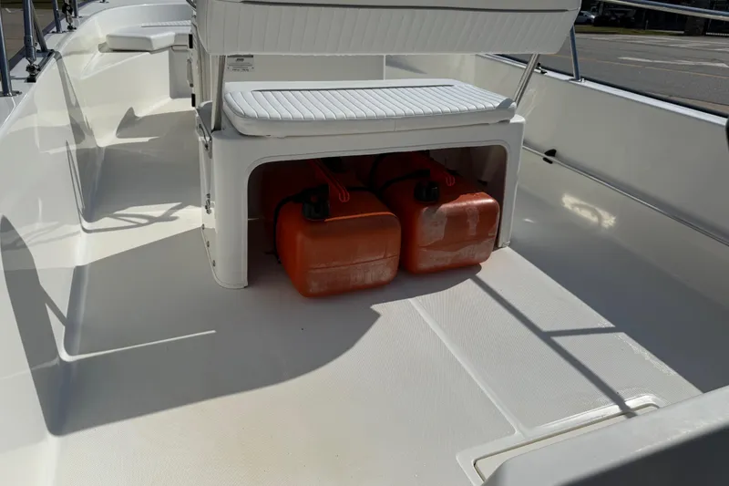 Slide: The Image of 2005 Boston Whaler 170 Montauk interior with storage and fuel tanks visible. - 22