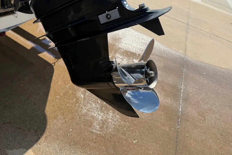 Slide: The Image of Close-up of a 2005 Boston Whaler 170 Montauk boat propeller on a wet surface. - 28