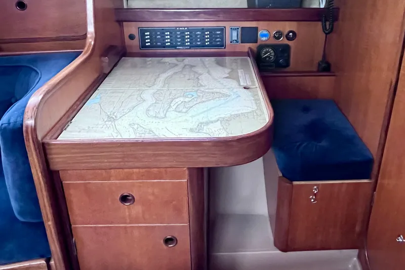 Slide: The Image of Navigation station on a 1985 Beneteau First 345 sailboat with chart table and instruments. - 12