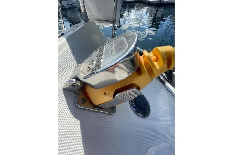 Slide: The Image of Deck detail of a 1985 Beneteau First 345 sailboat, featuring a chrome and yellow fitting. - 22