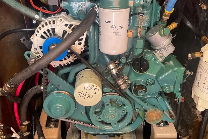 Slide: The Image of Engine of a 1985 Beneteau First 345 sailboat, showcasing mechanical components and filters. - 23