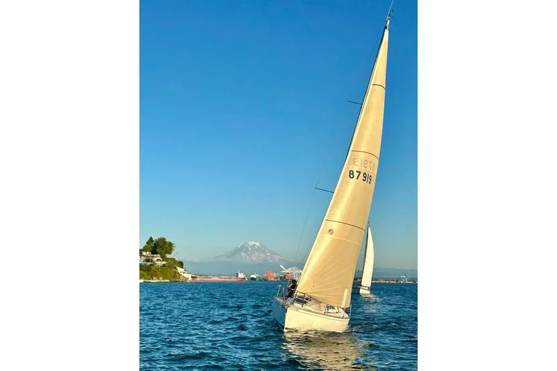 Slide: The Image of Sailboat Beneteau First 345 (1985) on blue water with mountain backdrop. - 24