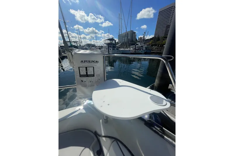 Slide: The Image of 1985 Beneteau First 345 sailboat with lifesaving equipment in a marina setting. - 4