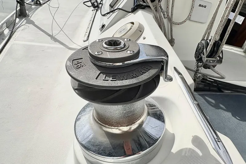 Slide: The Image of Winch on 1985 Beneteau First 345 sailboat deck, featuring Lewmar branding. - 6
