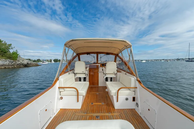 Slide: The Image of 2020 CH Marine Shelter Island Nomad boat interior with seating, on calm water. - 11