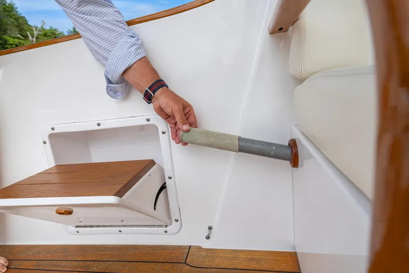 Slide: The Image of 2020 CH Marine Shelter Island Nomad interior detail with wooden seat and handrail. - 12