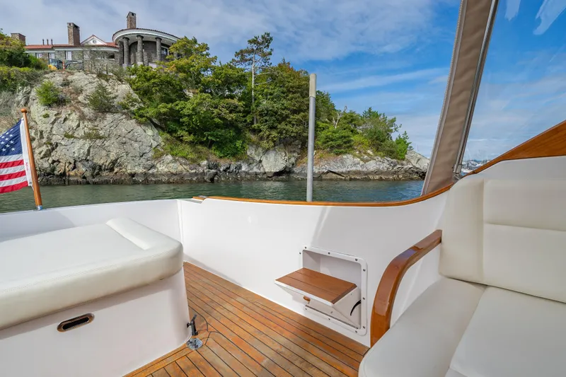 Slide: The Image of 2020 CH Marine Shelter Island Nomad boat interior with scenic coastal view. - 13