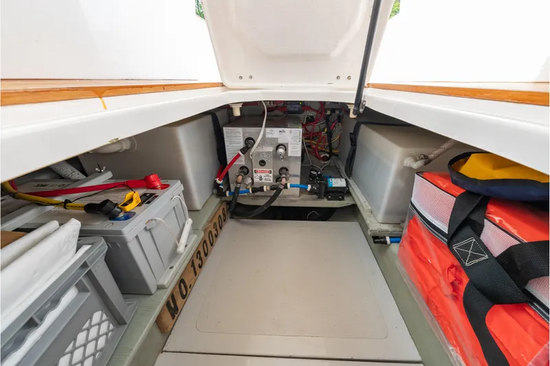 Slide: The Image of 2020 CH Marine Shelter Island Nomad storage compartment with equipment and supplies. - 19
